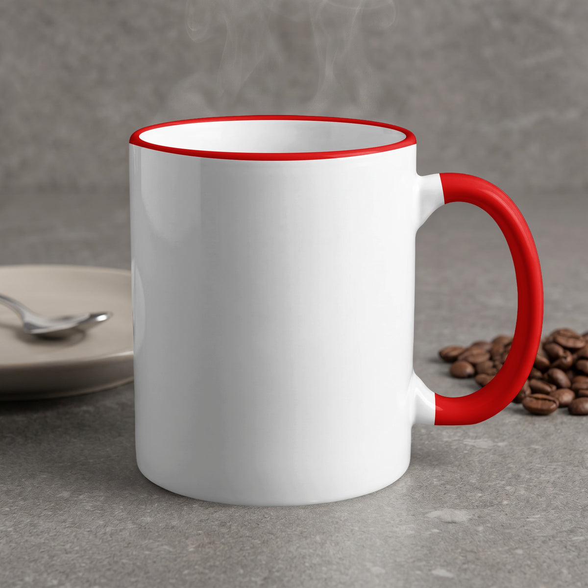 White mug with red rim and handle, steaming, with coffee beans and spoon.