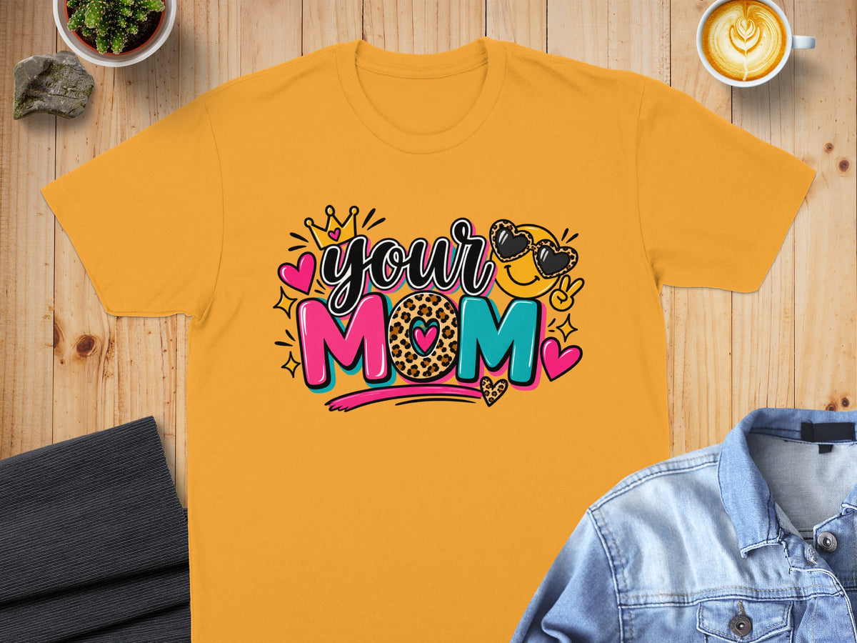 Orange t-shirt with "your MOM" graphic featuring a smiley face with heart sunglasses.
