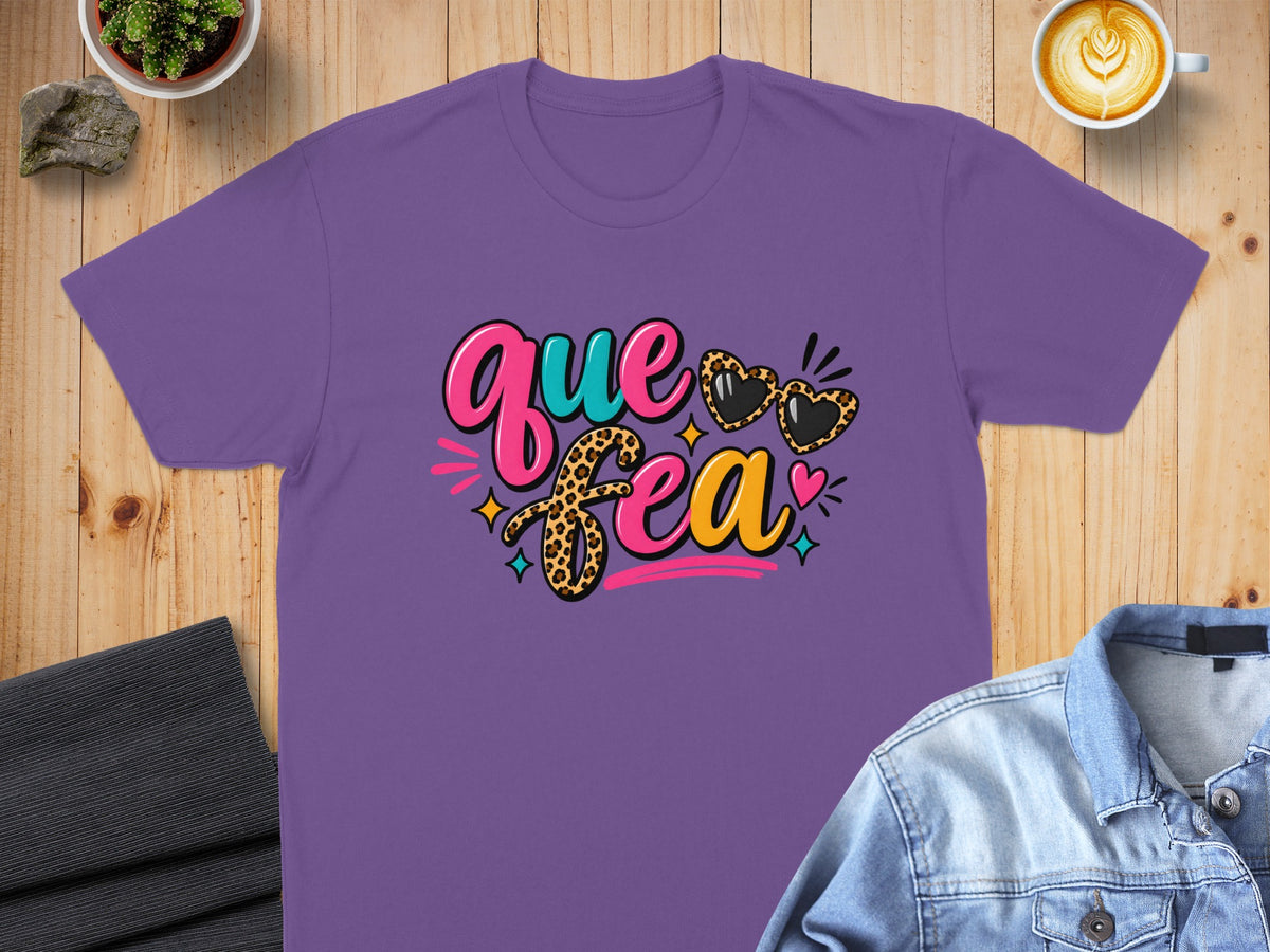 Purple t-shirt with "Que Fua" text and leopard print hearts.