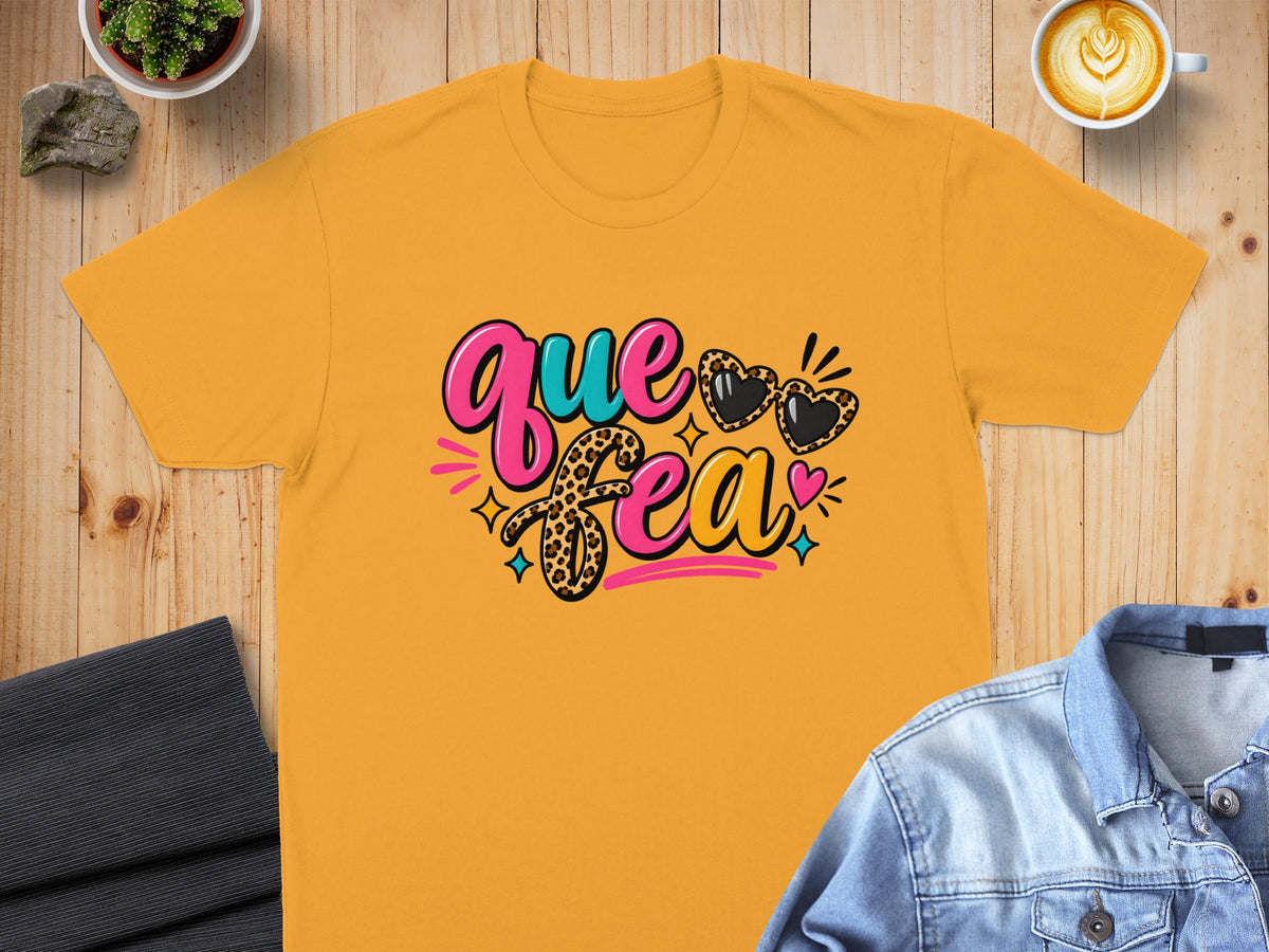 Yellow t-shirt with "que bea" text and leopard print hearts.