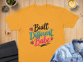 Yellow t-shirt with "Built Different, Babe" text and pink and teal hearts.