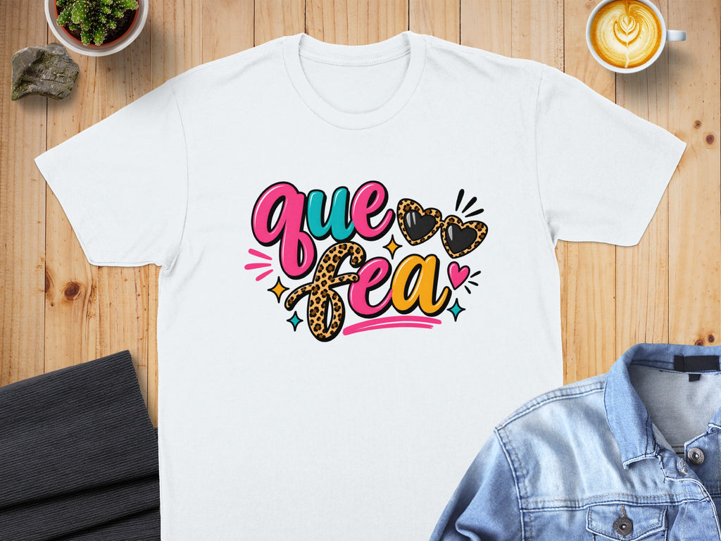 White t-shirt with "Que Sea" text, leopard print, and heart-shaped sunglasses.