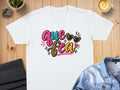 White t-shirt with "Que Sea" text, leopard print, and heart-shaped sunglasses.