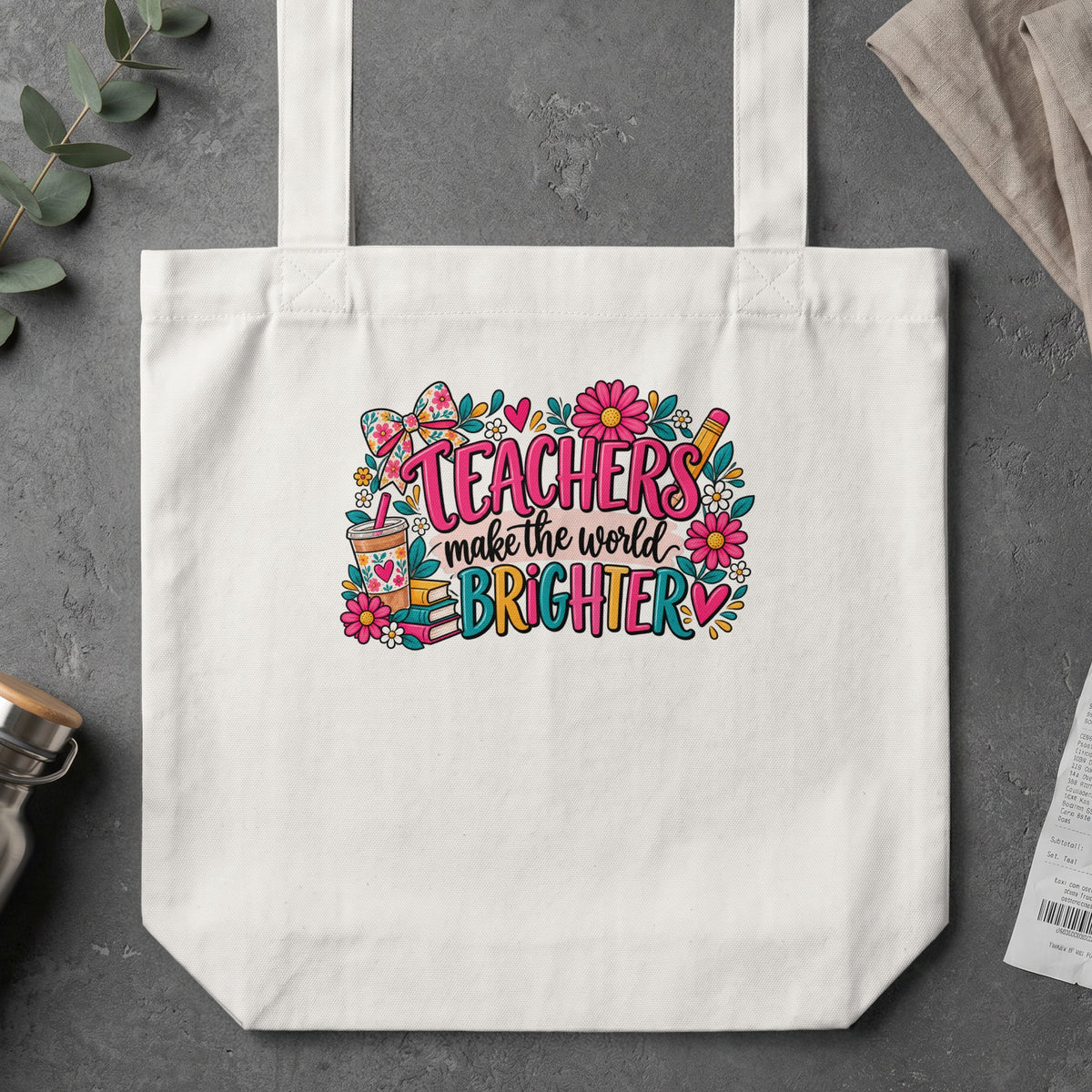 White tote bag with colorful "Teachers make the world brighter" graphic.