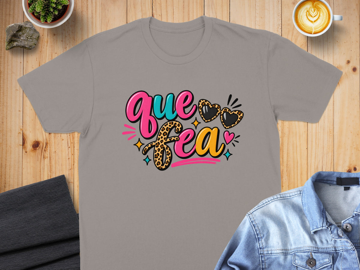 Grey t-shirt with "Que Feca" text and leopard print hearts.